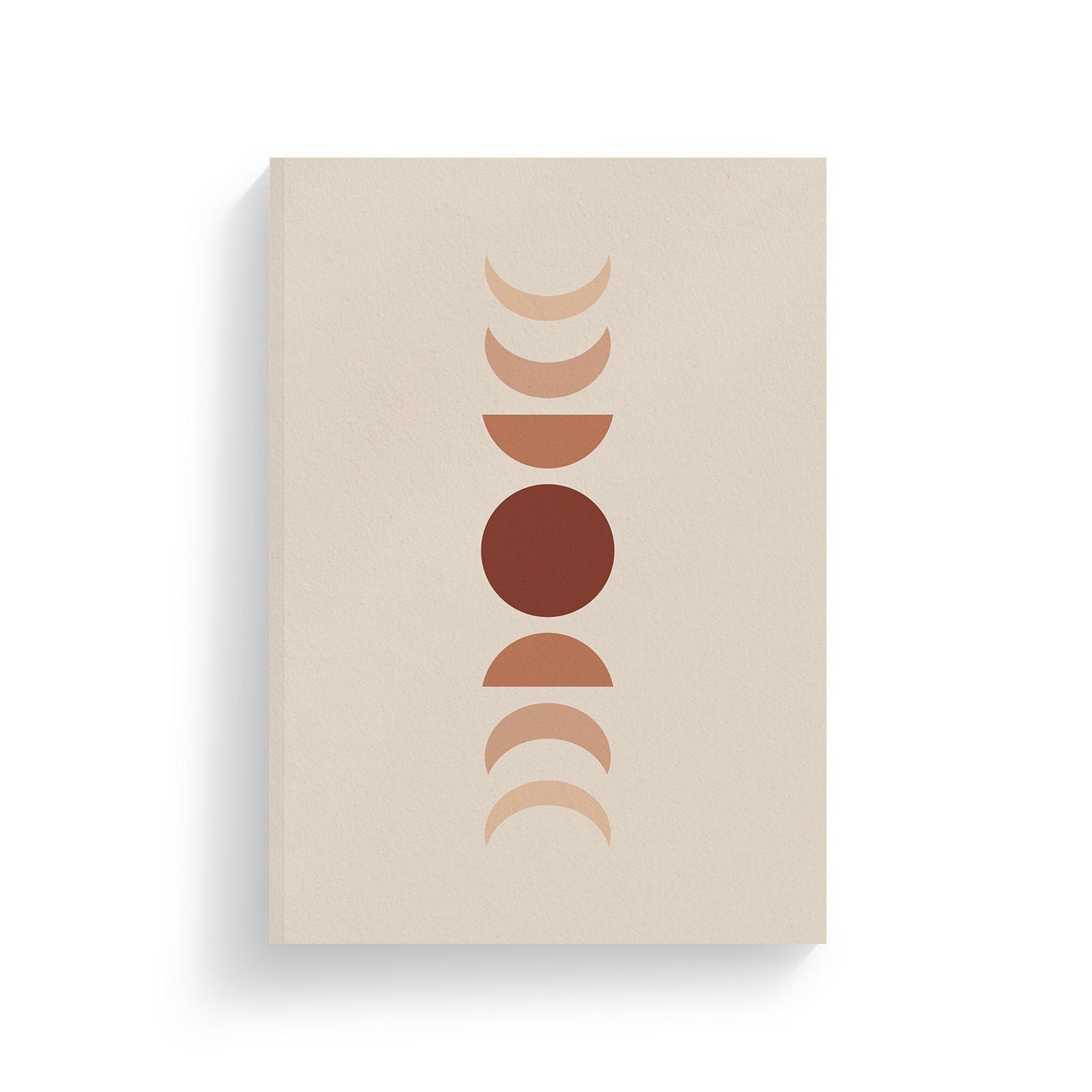 Cream colored notebook with red and orange moon phases down the center. 