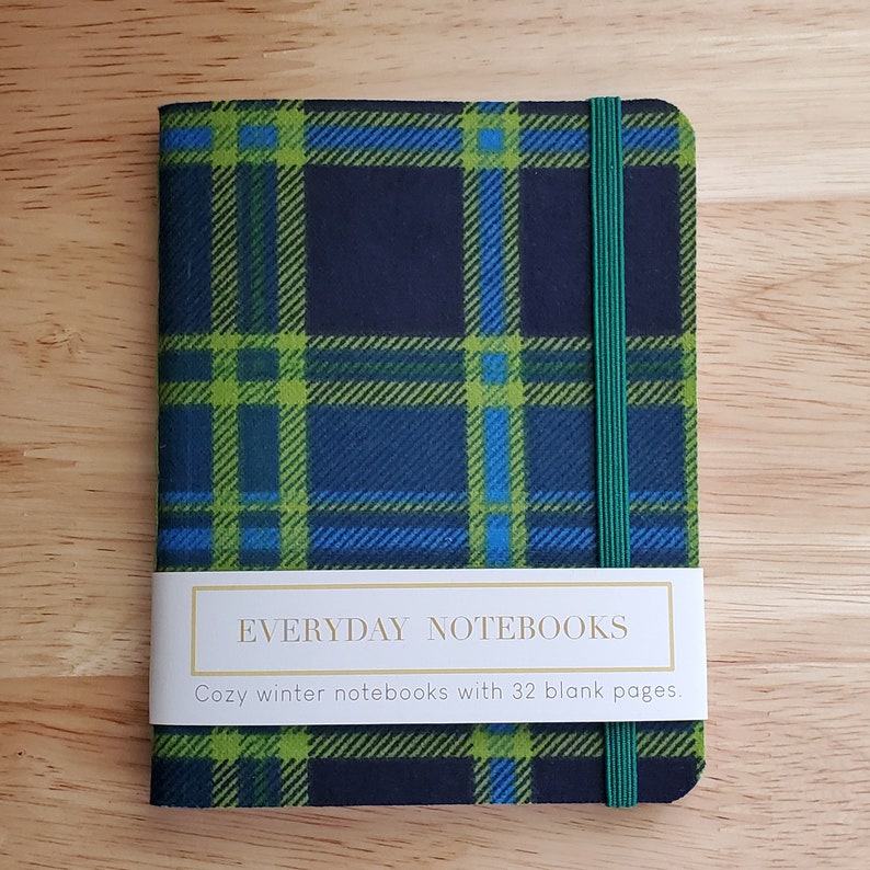 Image of a green plaid notebook on a table. 