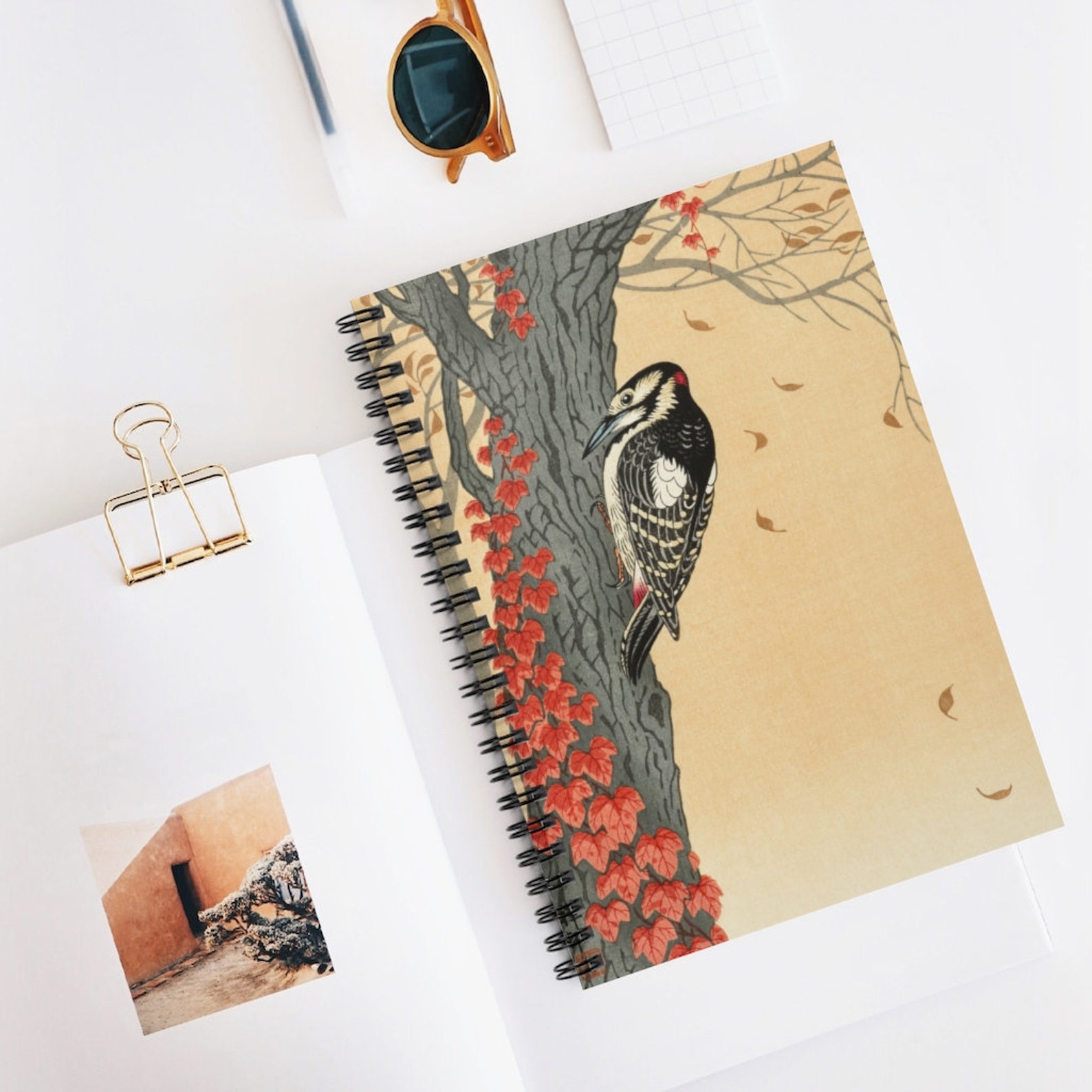 Image of a brown notebook with a woodpecker design. 