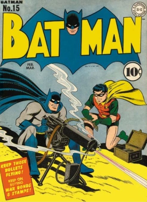 Batman #15 cover. Batman sits on the ground happily shooting a machine gun at an unseen target. Robin feeds the bullets into the gun.