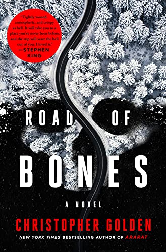 cover of Road of Bones by Christopher Golden; aerial image of snowy forest and road made up to look like a skull