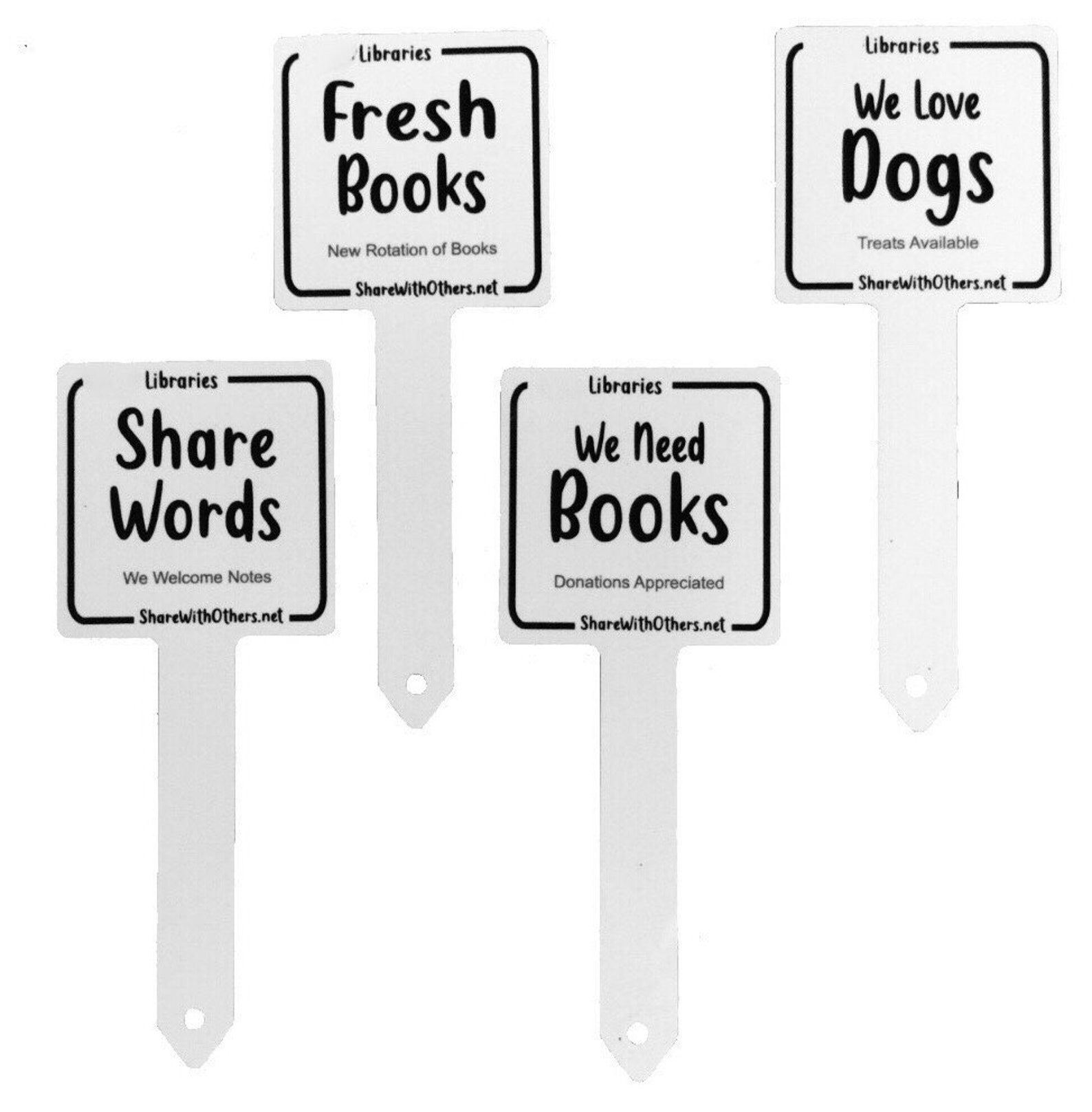 a set of four white flip signs that read "share words," "we need books," "we love dogs," and "fresh books"