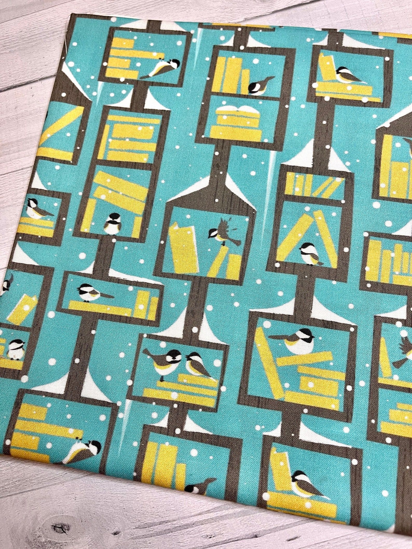 A book sleeve made of blue fabric depicting LFL's in a wintry scene.