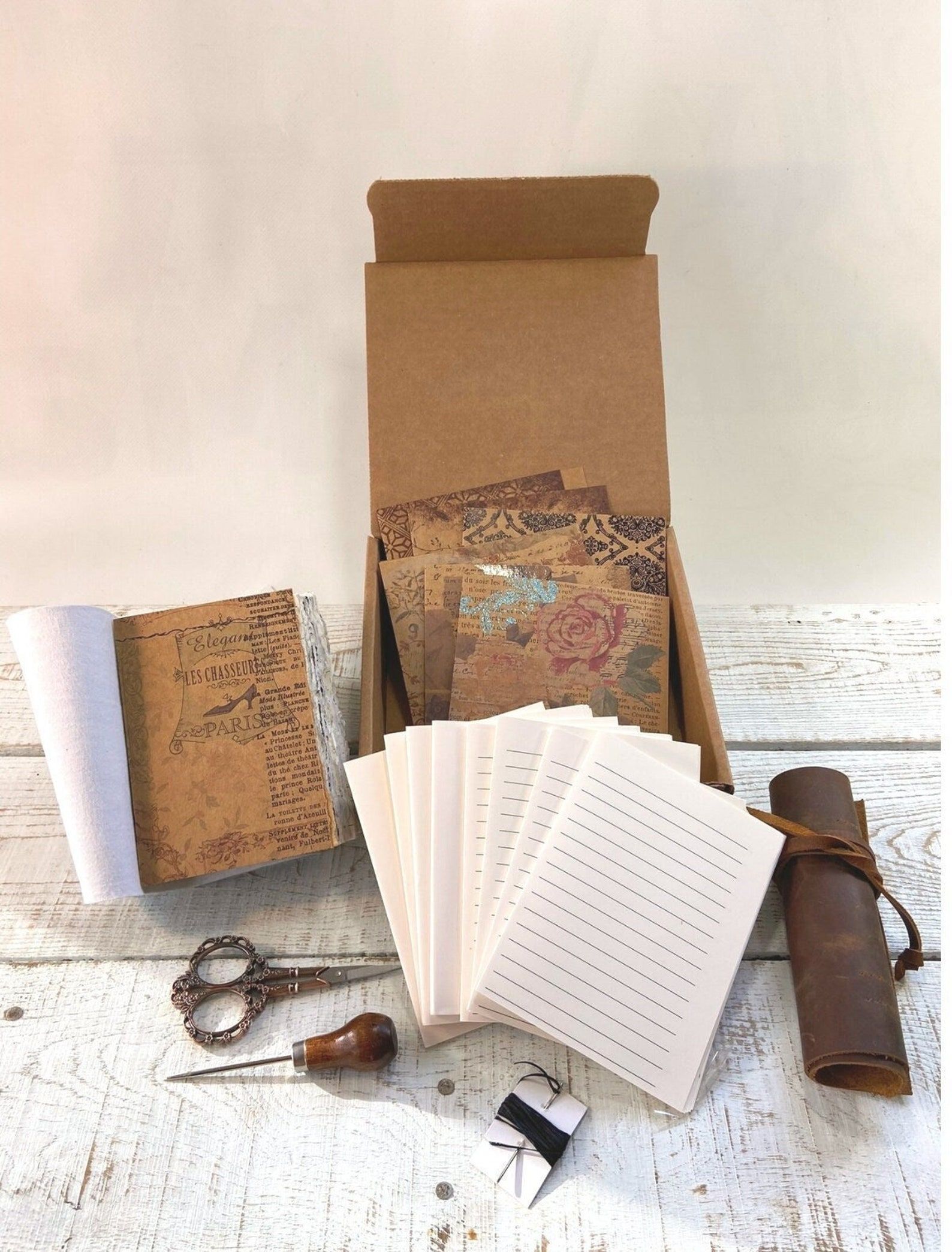 Materials for book binding included in a kit to make a leather journal.