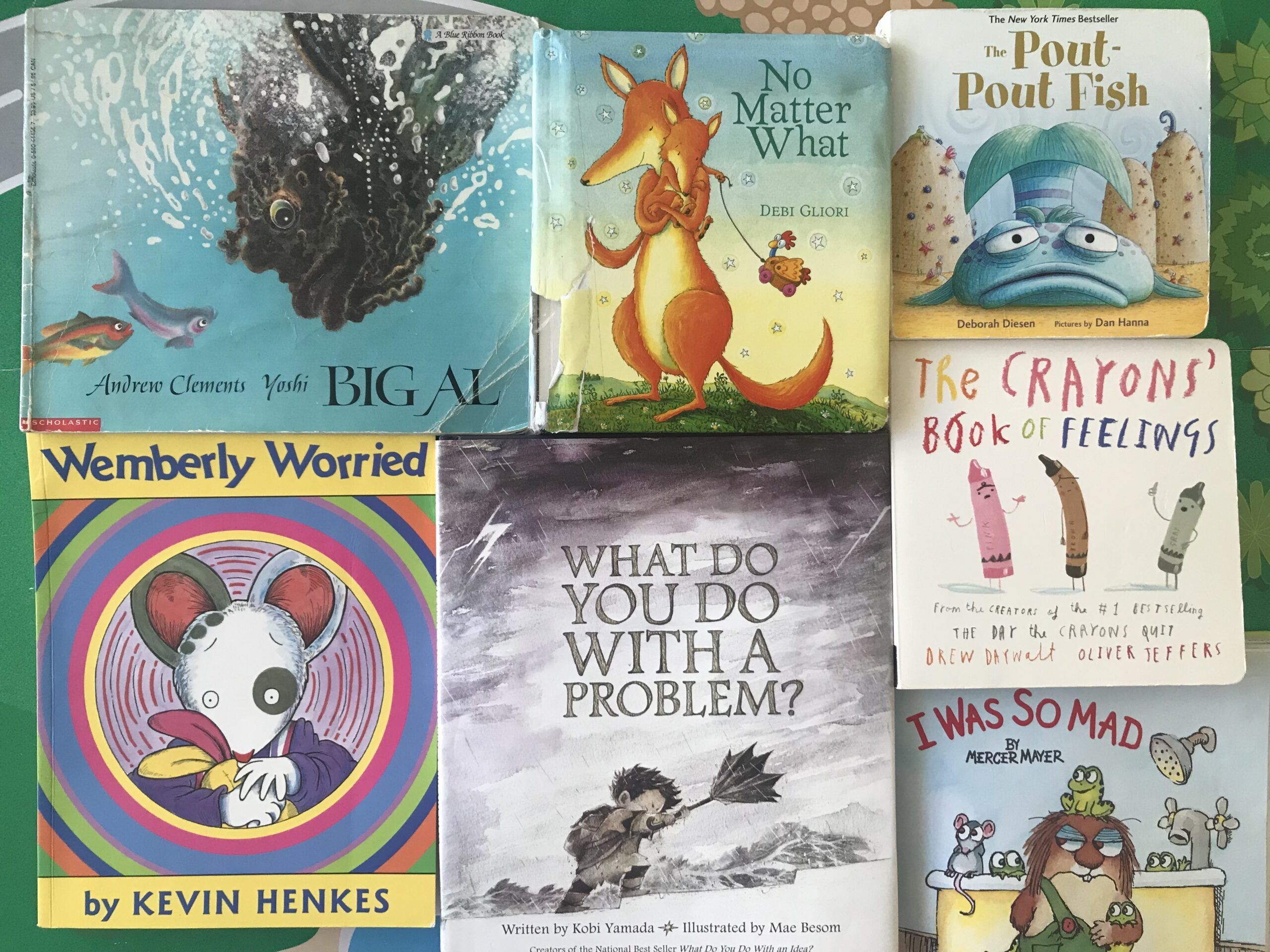 Image of seven children's books, all featuring negative emotions. 