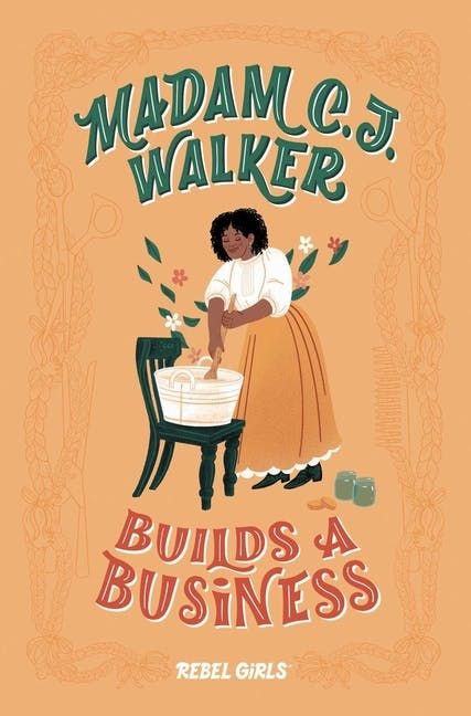 A Black woman in an old-fashioned tan skirt and white shirt reaches into a white tub on a chair. This is the cover for Madam C.J. Walker Builds A Business by Rebel Girls