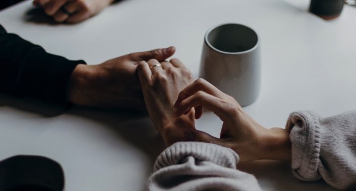 one person holding both of another person's hands