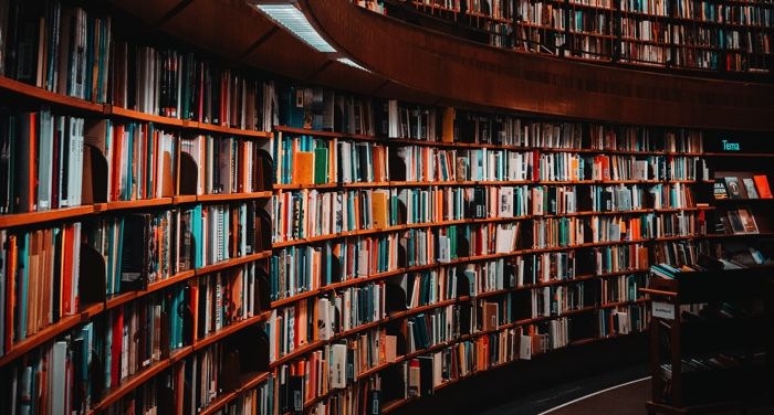 curved shelves of books in a library