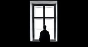 man standing in front of the window