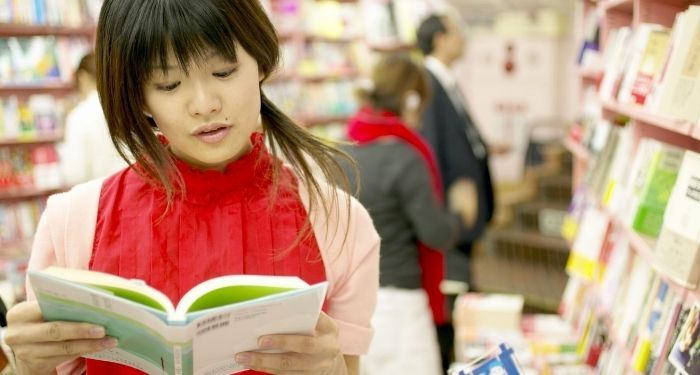 Image of an Asian woman in a bookstore