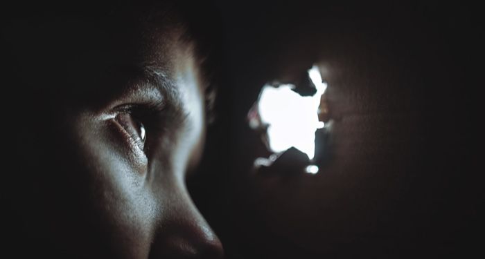 person watching through hole