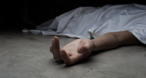 a photo of a white woman, presumably dead, under a sheet, with only her limp hand visible