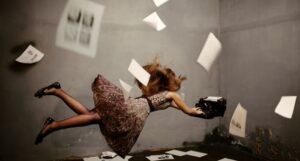 woman floating midair while trying to type on a typewriter