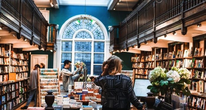 bookstore full of people and shelves filled with books