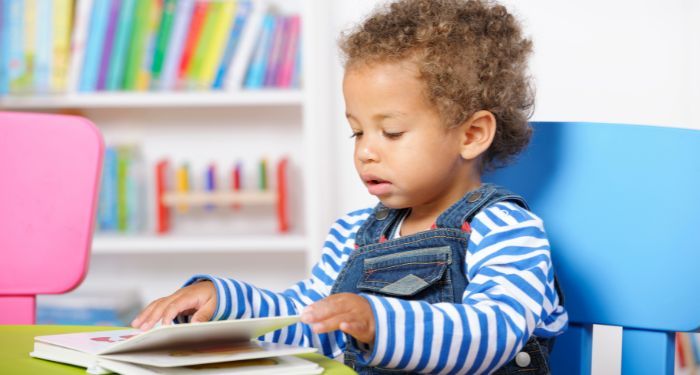 image of a Black child reading a book