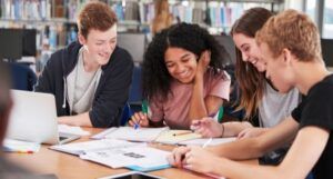 Group of Students Collaborating on Project in Library