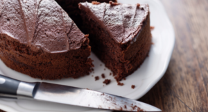 a photo of a chocolate cake with a slice out of it