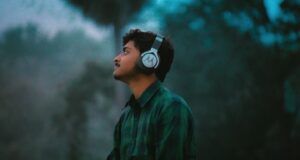 light brown-skinned man wearing headphones