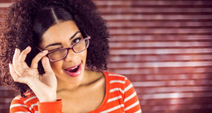 image of a Black woman with glasses winking