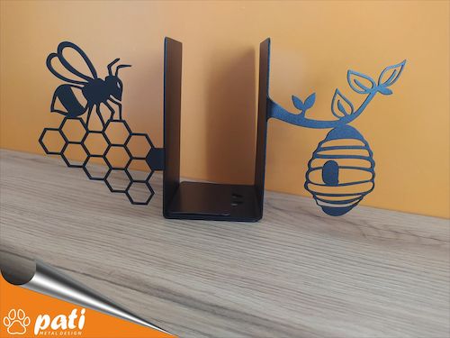 metal bookends cut into the shape of a bee on honeycomb and a beehive