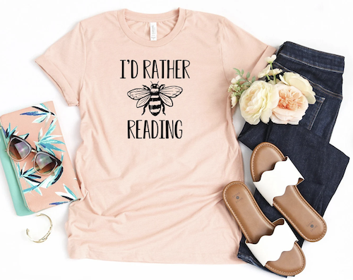T-shirt with black and white print of bee that says I'd rather bee reading