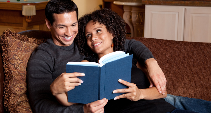 a photo of a couple reading a book together