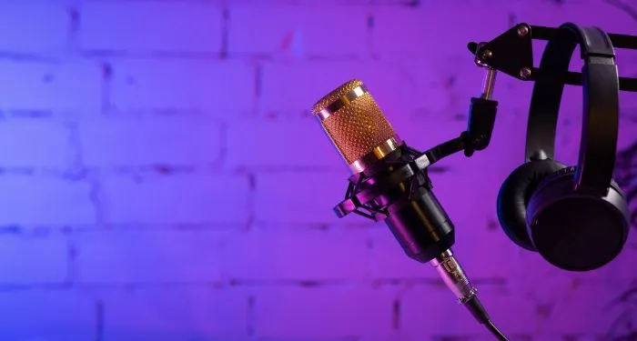 microphone and headphones on purple background