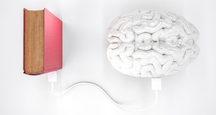 image of a brain connected to a book by a power cord