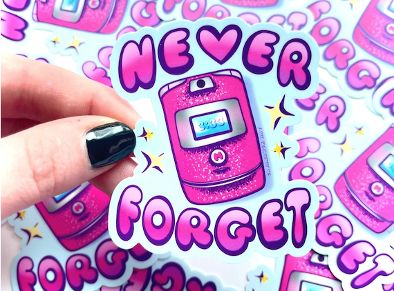 A sticker featuring a pink Razor cell phone and the words 'never forget.'