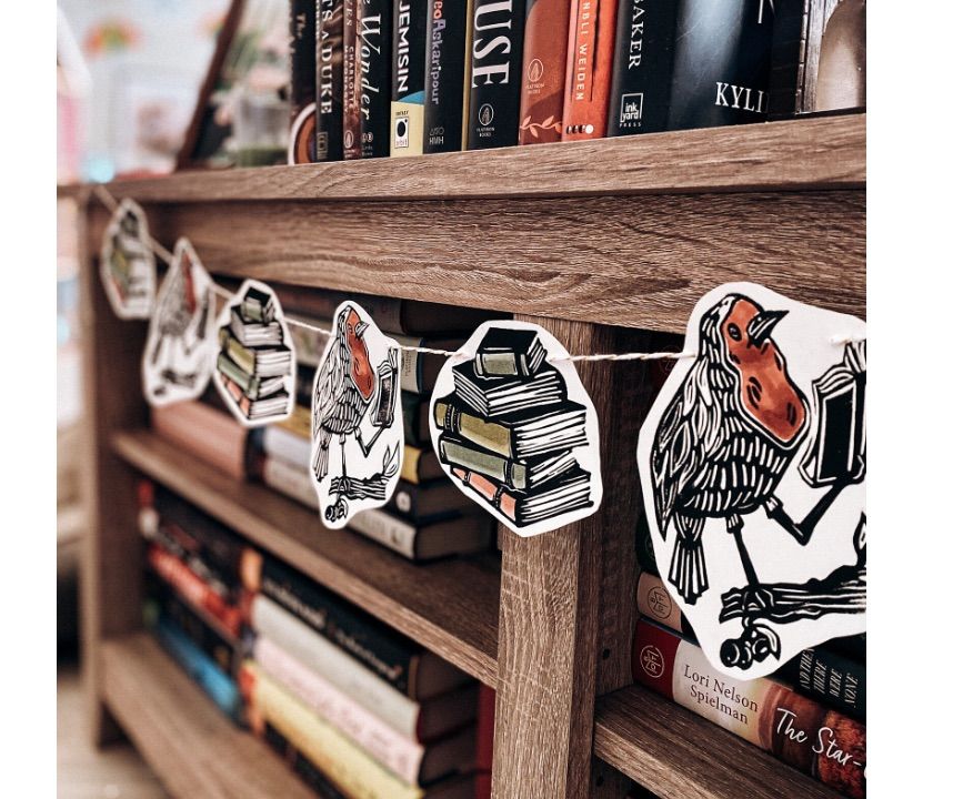 Image of book-themed garland of birds reading books. 