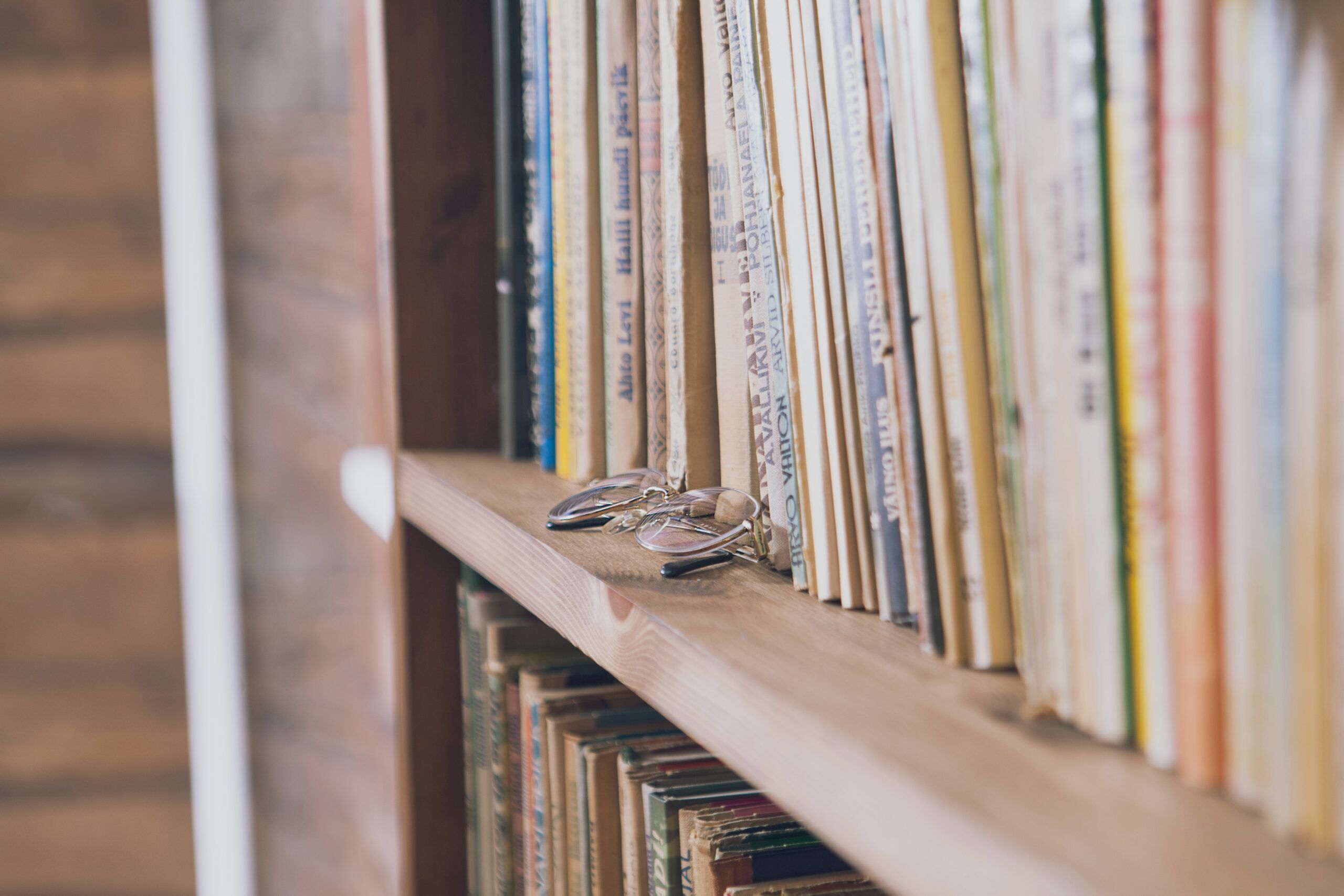 a photo of a bookshelf with glasses