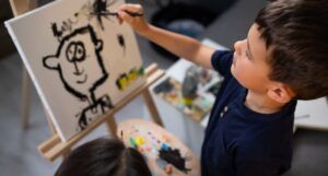 Image of a young boy painting