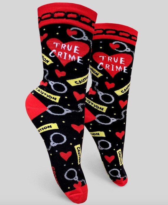 Socks with the words "True Crime" in a heart and featuring a pattern of caution tape, hearts, and handcuffs.