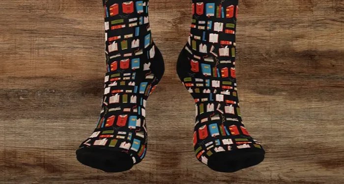 Tall black socks with a pattern of red, blue, and green books