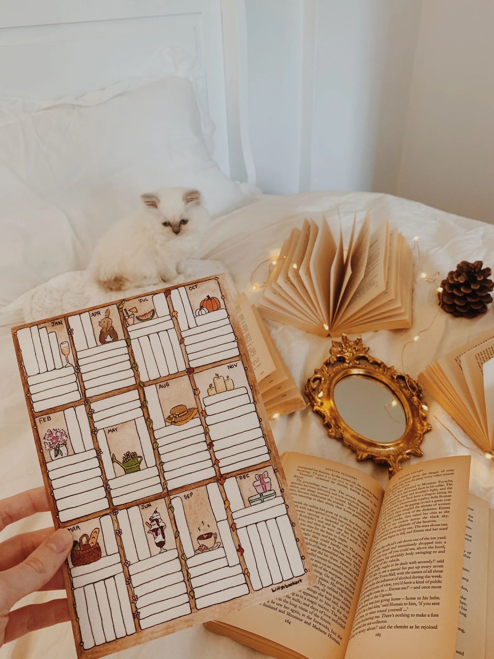 single page monthly book tracker styled as piled of books on a shelf