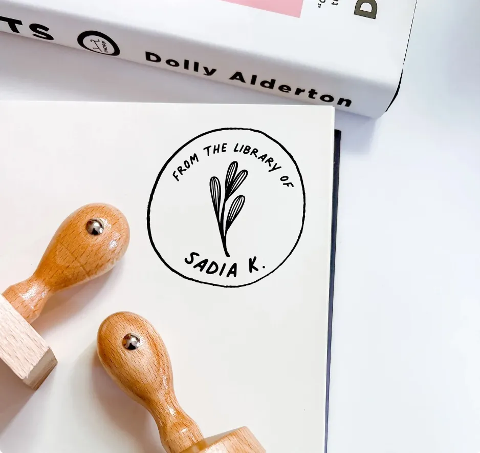 Image of two wooden book stamps, with an image of what the stamp itself looks like.