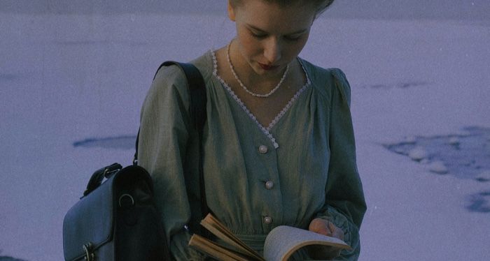 fair-skinned woman reading snow