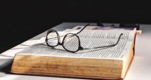 glasses on top of an open book