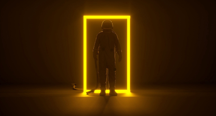 a photo of a person wearing a spacesuit in a dark area standing in a doorway light up bright yellow