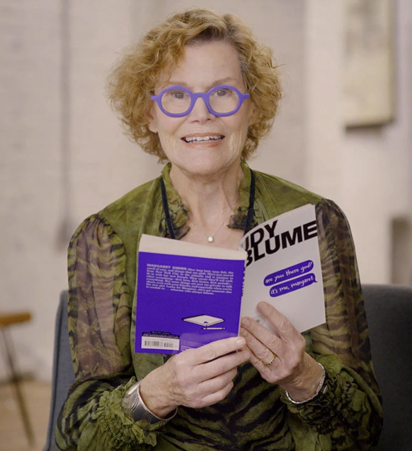 Judy Blume holding her book Forever still