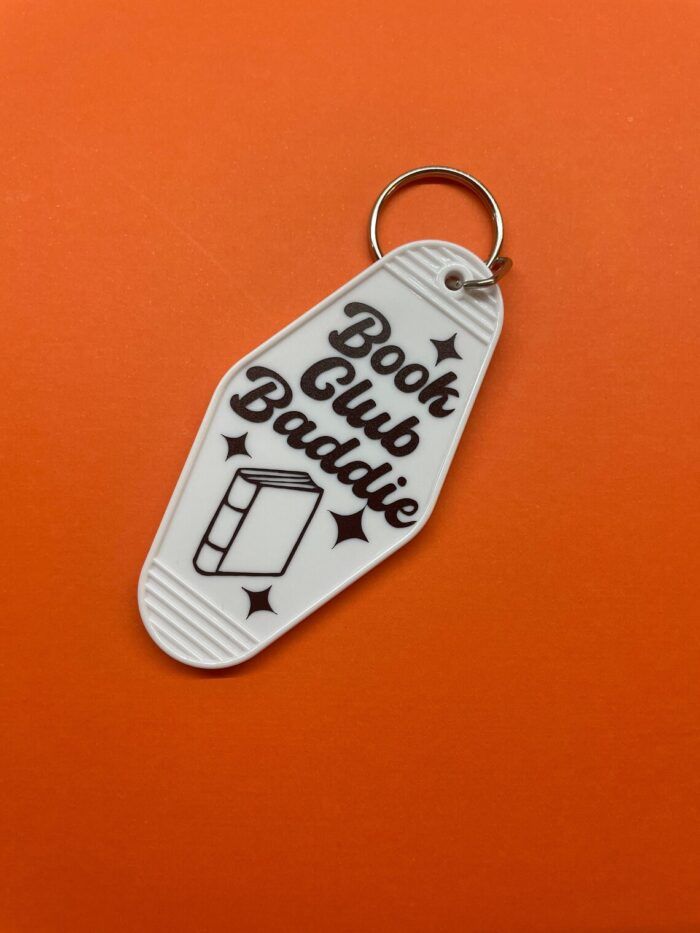 retro motel keychain with the words "book club baddie" in script