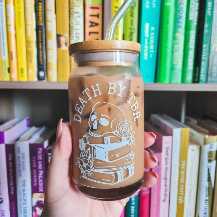 glass cup with the words "death by TBR" and a skull on top of books 