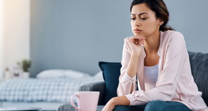 Image of a brown woman deep in thought