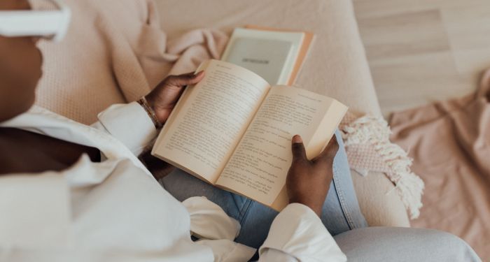 Image of a Black woman reading a book