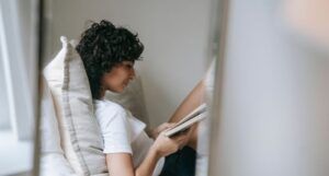 Image of an olive skinned person reading a book