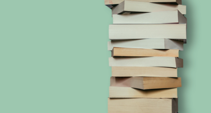 a photo of a stack of paperback books again a green background