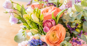 a photo of a bouquet of pink, orange, and yellow flowers