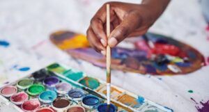 Image of a Black hand and watercolor paints