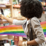 a photo of someone browsing books with a rainbow watercolor illustration superimposed behind them