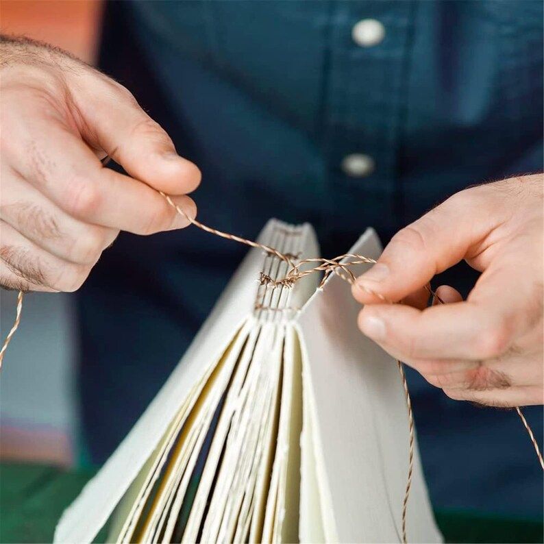 Hands tying up book